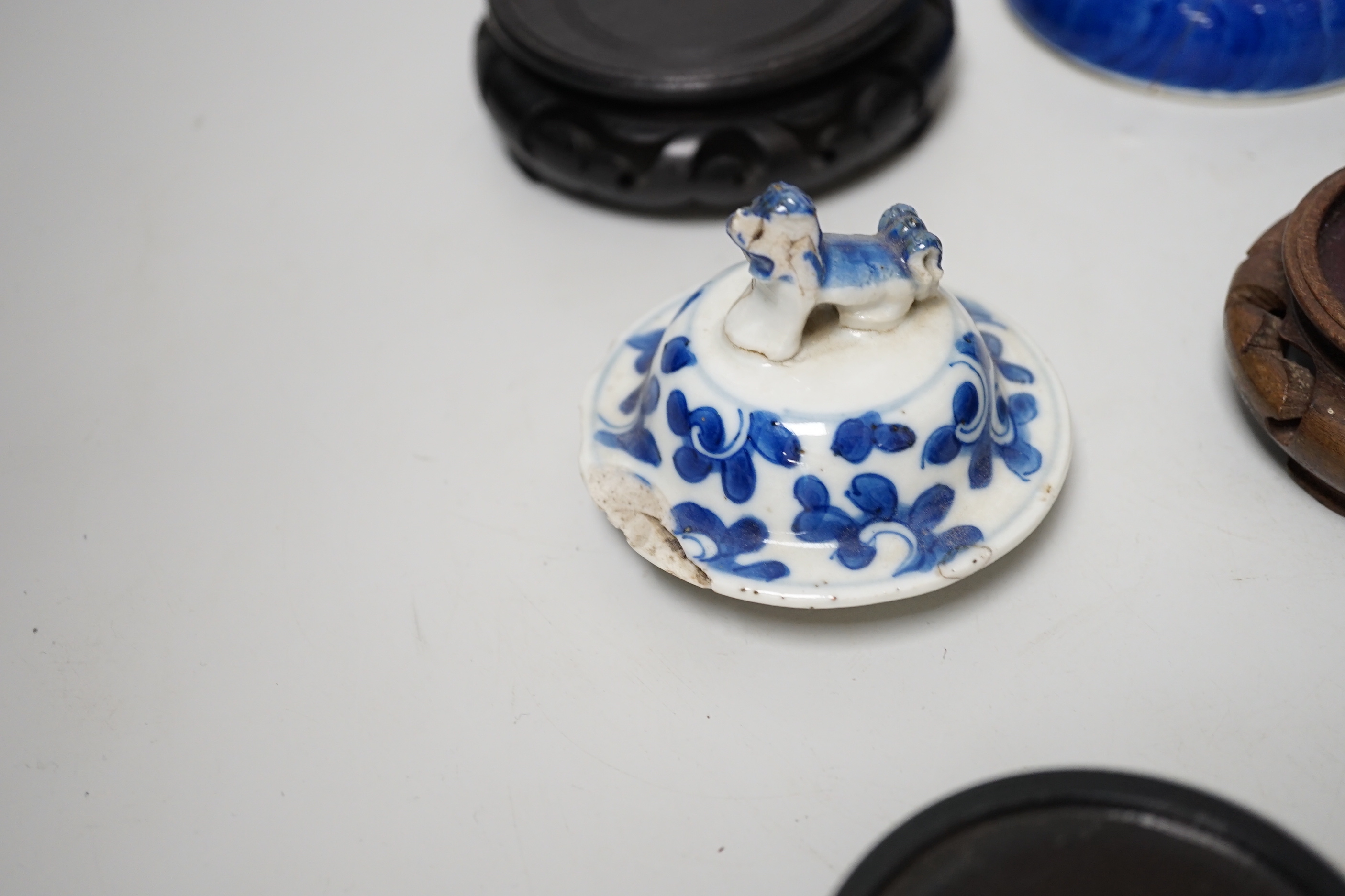 A group of Chinese wooden stands and ceramic lids